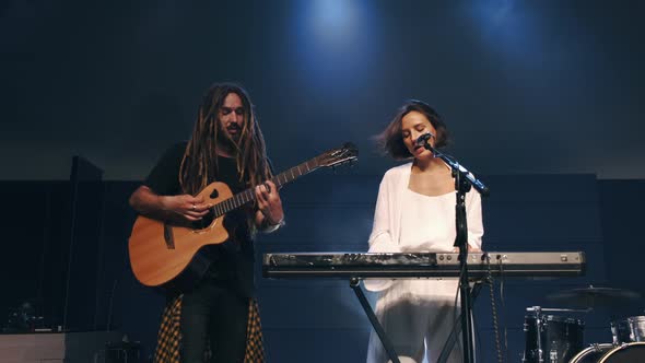 Female Singer and Musician Performing on Stage