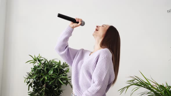 Young Woman Sing at Home