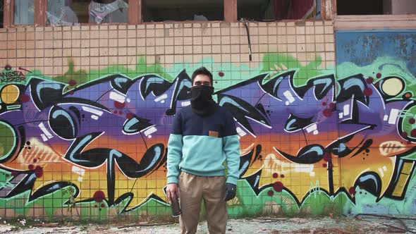 Portrait of Young Man Graffiti Artist on Graffiti Wall Background