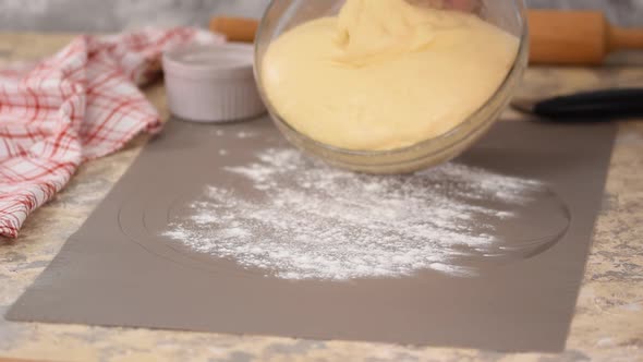 Female Working with the Dough. Putting Yeast Dough on a Work Surface