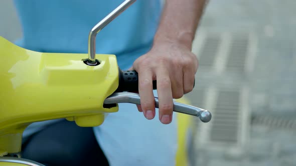 Male Hand on Motorbike Throttle.