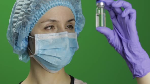 Female Scientist Holding Ampoule in Hand, New Medication Developing, Vaccination