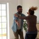 two happy people giving a hug after buy a new house or apartment relocating some boxes and packs - VideoHive Item for Sale