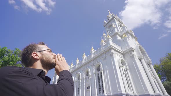 The person who looks at the church and prays.