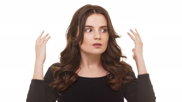 Confused Caucasian Beautiful Brunette Female Standing at a Loss on White Background