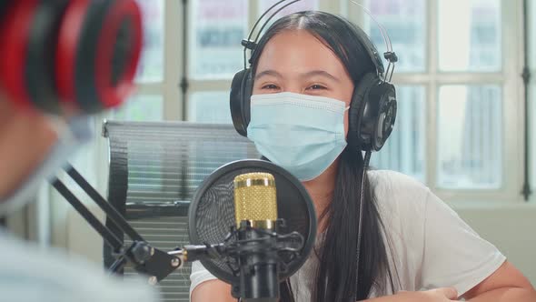 Over Shoulder View Of Boy Interview Kid Girl Guest Wearing Protect Mask In Podcast Studio