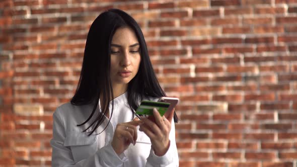 The Girl Donates Money To a Charity Fund, Paying with a Bank Card Through the Phone