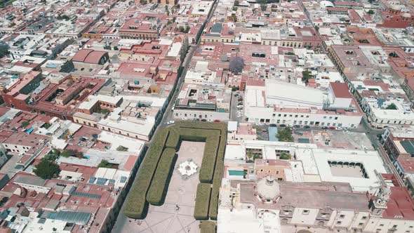 Frontal view of gardens and church in downtown queretaro in Mexico