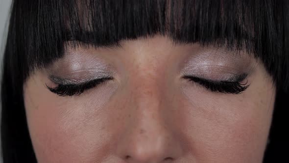 Closeup Portrait of Young Beautiful Caucasian Female Face with Pretty Dark Eyes Thoughtfully Looking