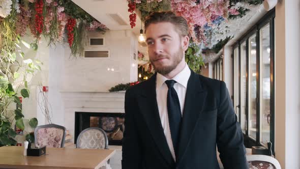 Handsome Man in Smart Wearing Approaching To His Partner at Restaurant