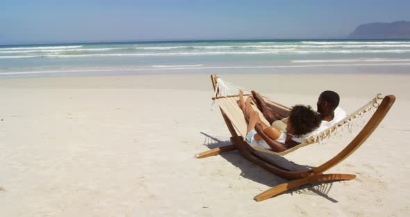 Couple interacting with each other while lying in a hammock 4k