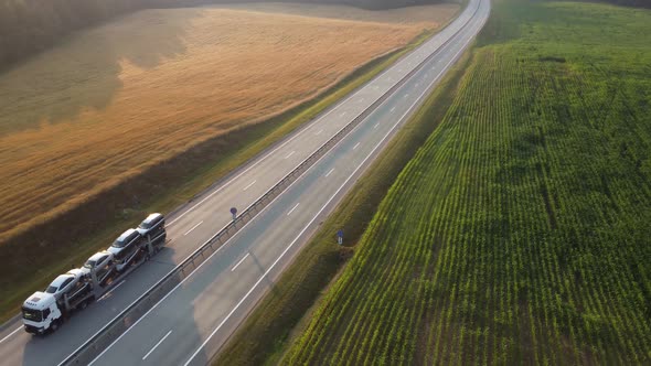 Aerial drone footage: Large car transporter (car hauler) delivery truck is fully loaded