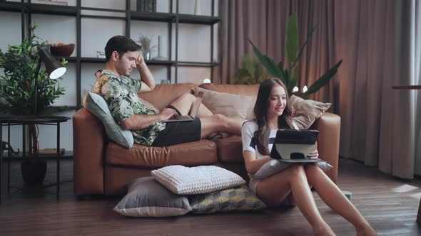home isolate quarantine,asian and caucasian marry couple sit relax using laptop