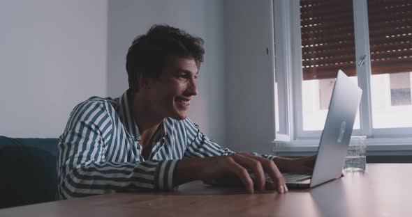 Young man enjoying video call and receiving good news