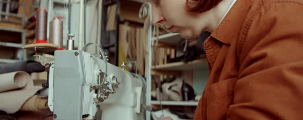 Woman Working With Sewing Machine in Workshop