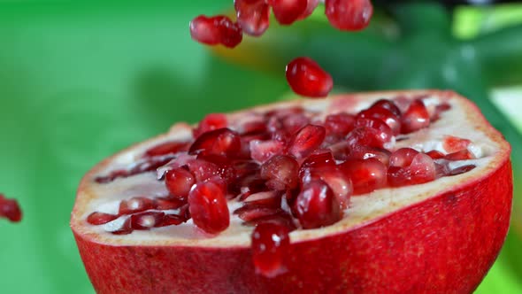 Super Slow Motion Shot of Falling Seeds on Fresh Pomegranate at 1000Fps