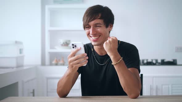 Excited Man Looking at Smartphone Celebrate Success Mobile Win Online Bet