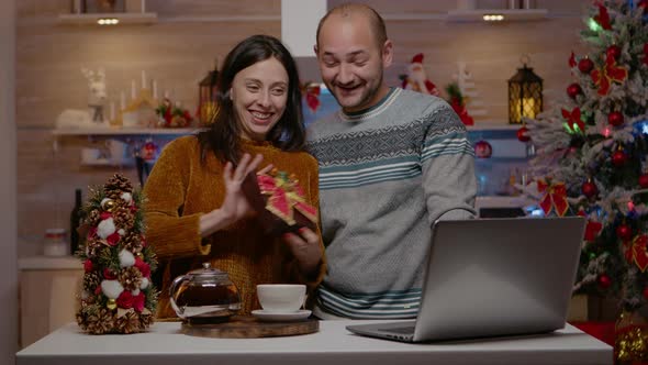 Festive Couple Giving Presents on Video Call Conference