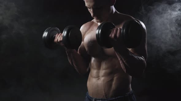 Athletic Young Man with Dumbbell