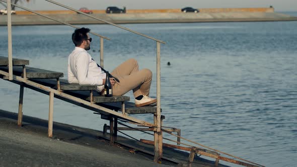 Businessman Enjoying View And Celebrating. Successful Man Drink Champagne And Relaxing Near River.