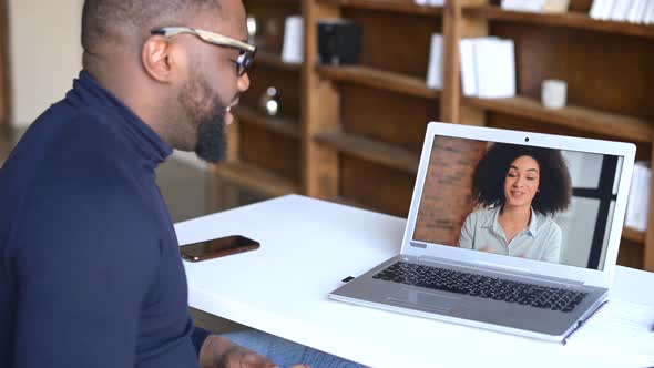 AfricanAmerican Man Making Video Call with His Female Friend or Coworker