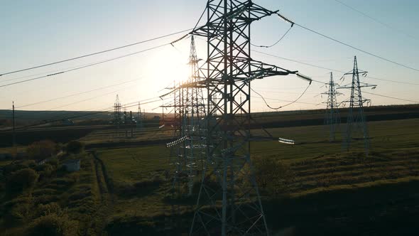 Aerial View of Electricity Pylons and High Voltage Power Line at Sunset