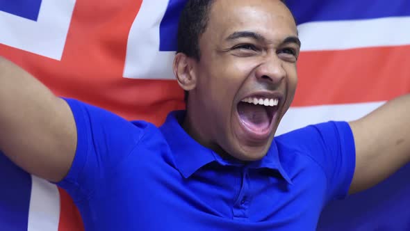 Icelandic Fan Celebrating while Holding the Flag of Iceland