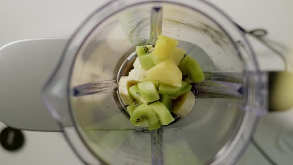 Pinapple Chunks are Thrown Into Blender to Make Smoothie