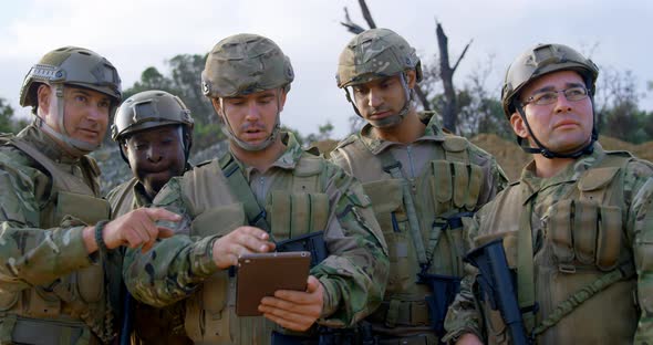 Front view of military soldiers using digital tablet during training 4k