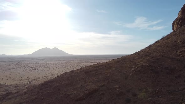 Stunning dawn in the desert, gorgeous sun is shining from behind a mountain