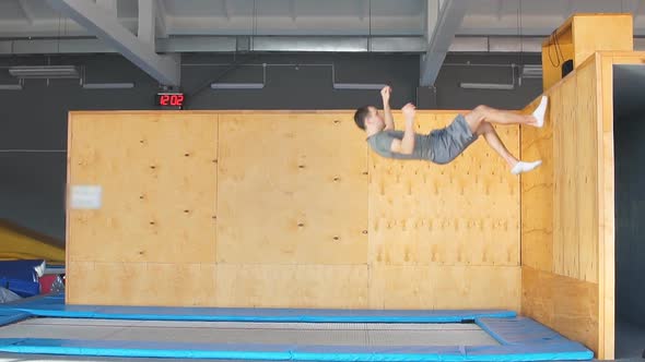 Trampoline Jumper Performs Complex Acrobatic Exercises on the Trampoline