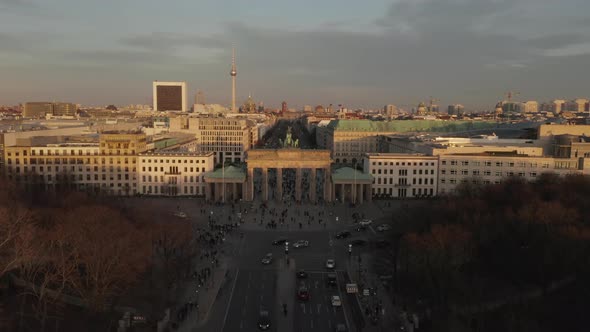 AERIAL: Brandenburg Gate in Berlin with View on Alexanderplatz TV Tower in Beautiful Sunset Light 