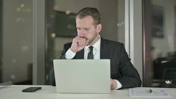 Sick Businessman Having Coughing in Office at Night