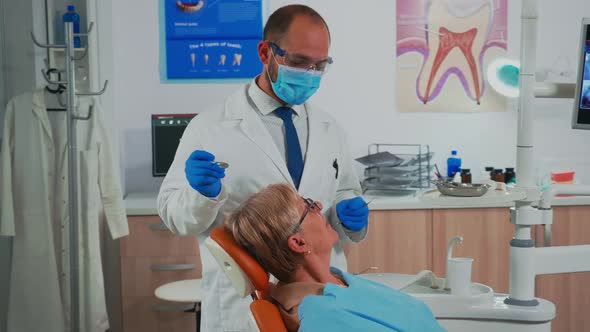 Orthodontist Examinating Patient Using Sterile Dental Tools