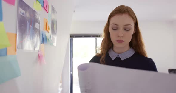 Caucasian woman working in creative office