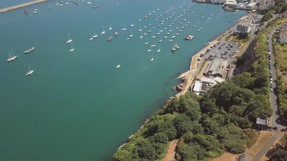 Overhead view of Brixham Harbour in England. Boats are docked in a harbour in southwest England.