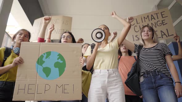 Multiethnic Group of Teen on a Protest March Carrying Signs with Environmental and Conservation