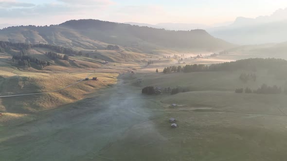 Sunrise in the Dolomites mountains with fog and mist