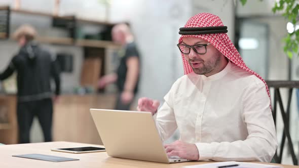 Professional Young Arab Businessman Doing Video Call on Laptop in Office 