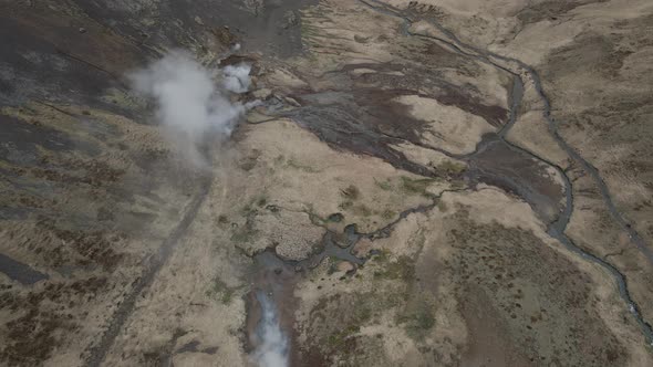 Fumaroles and thermal waters at Reykjadalur in Iceland. Aerial forward tilt up