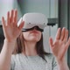 Close up of woman wearing vr goggles and reaching toward lens direction with hands - VideoHive Item for Sale