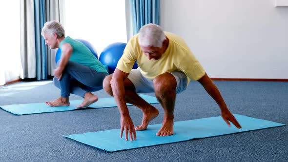 Senior citizens performing stretching exercise