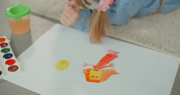 Child Hands Creating Picture with Colorful Paints