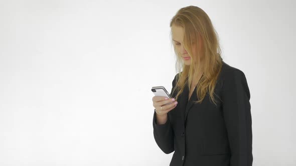 In Studio a Young Girl Working on a Mobile Phone