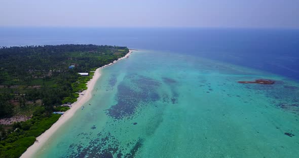 Wide angle birds eye island view of a summer white paradise sand beach and turquoise sea background 