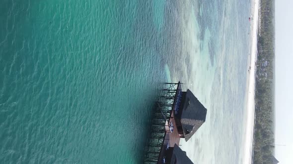 Vertical Video House on Stilts in the Ocean on the Coast of Zanzibar Tanzania Aerial View