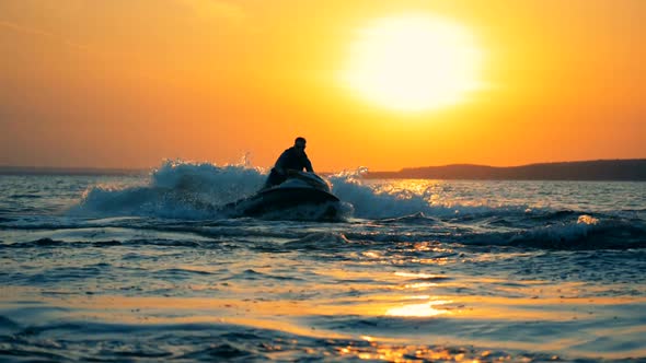 A Person Is Crossing the Sea While Riding a Water Scooter