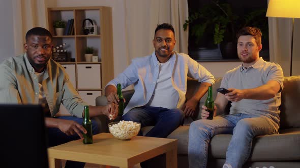 Happy Male Friends with Beer Watching Tv at Home