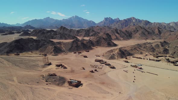 Top view of the Sahara desert, desert mountains. Wooden Bedouin houses.