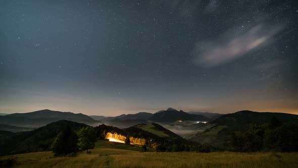 Stars over Mountains and Rural Landscape